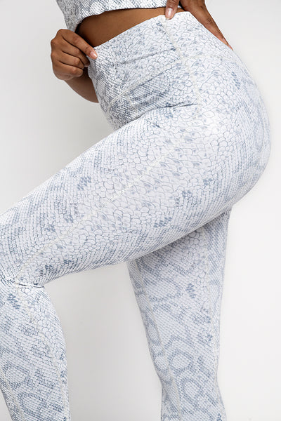   High waisted pale snake print gym leggings, wide supportive waistband. Detailing seams down the front and back of the legs, compressive flattering fit. ⅞ leg length  