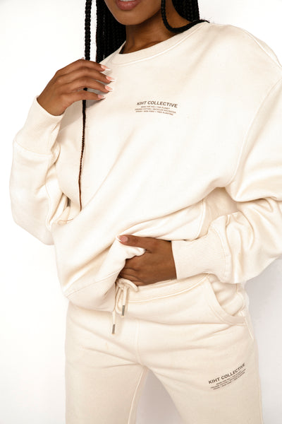 Girl wearing KIHT Collective sweat shirt in cream shot of print design 